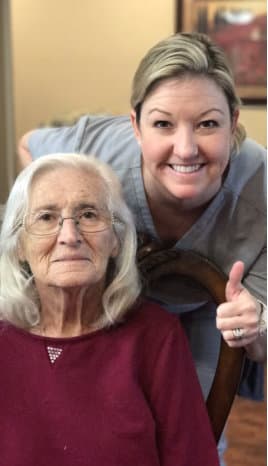 caregiver and elderly man smiling