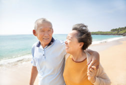 caregiver and an elderly woman smiling at the camera