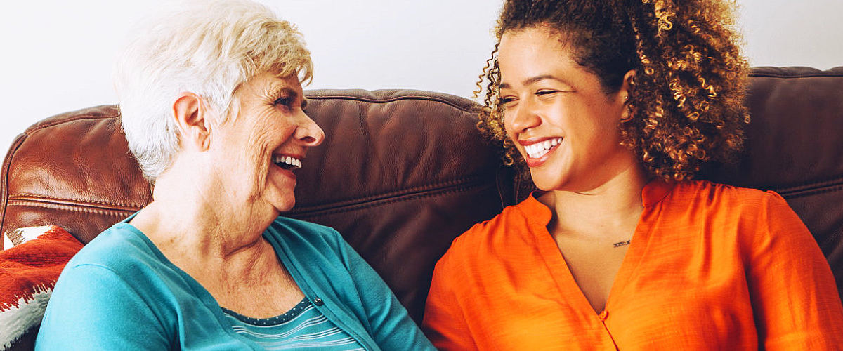 caregiver and an elderly woman chatting